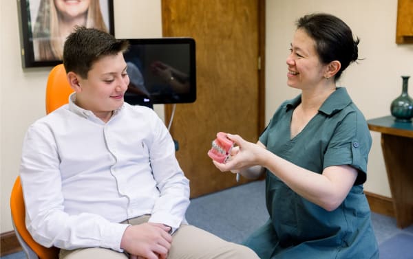 Dr. Diane with a patient demonstrating treatment with braces.